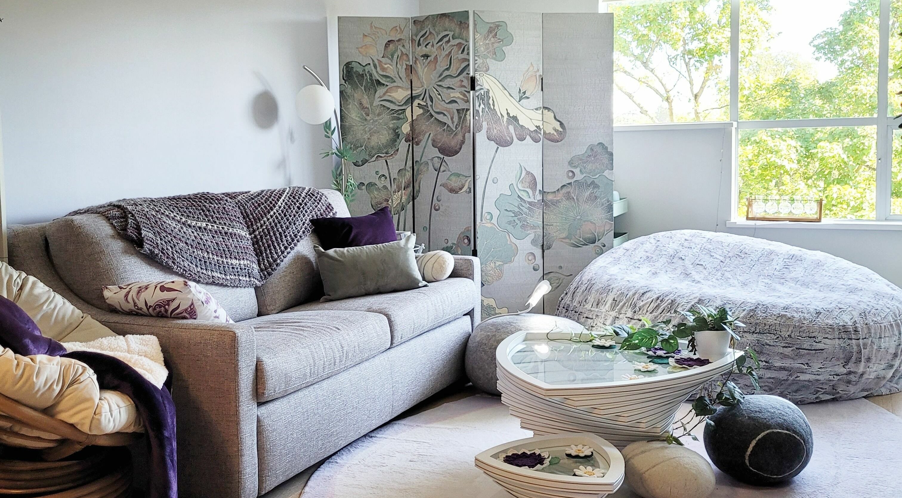 Tranquil relaxation space at Ai-Lashes, Victoria, British Columbia, CA. Cozy couch, soft lighting, floral decor.