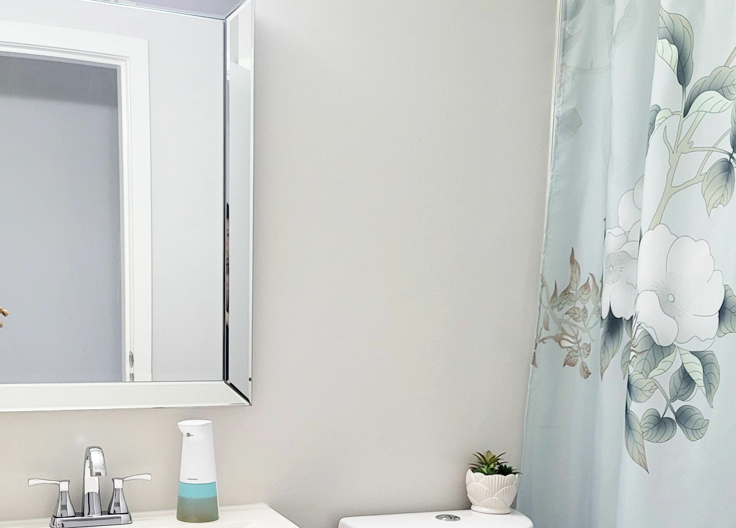 Elegant bathroom at Ai-Lashes in Victoria, British Columbia, CA, featuring floral decor and modern amenities.