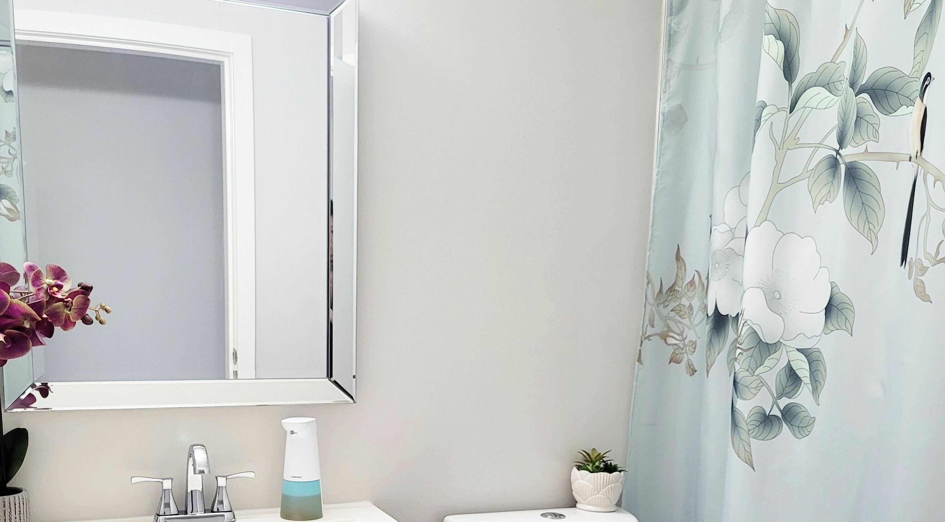 Elegant bathroom at Ai-Lashes in Victoria, British Columbia, CA, featuring floral decor and modern amenities.