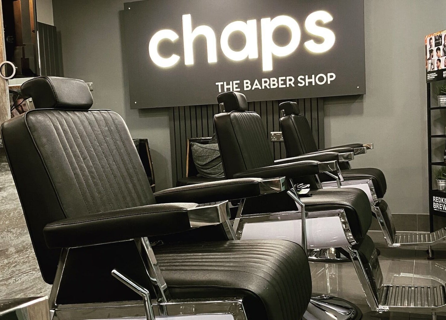 Modern barber chairs at Chaps The Barbershop in Edinburgh, Scotland, GB reflecting sleek design and comfort.
