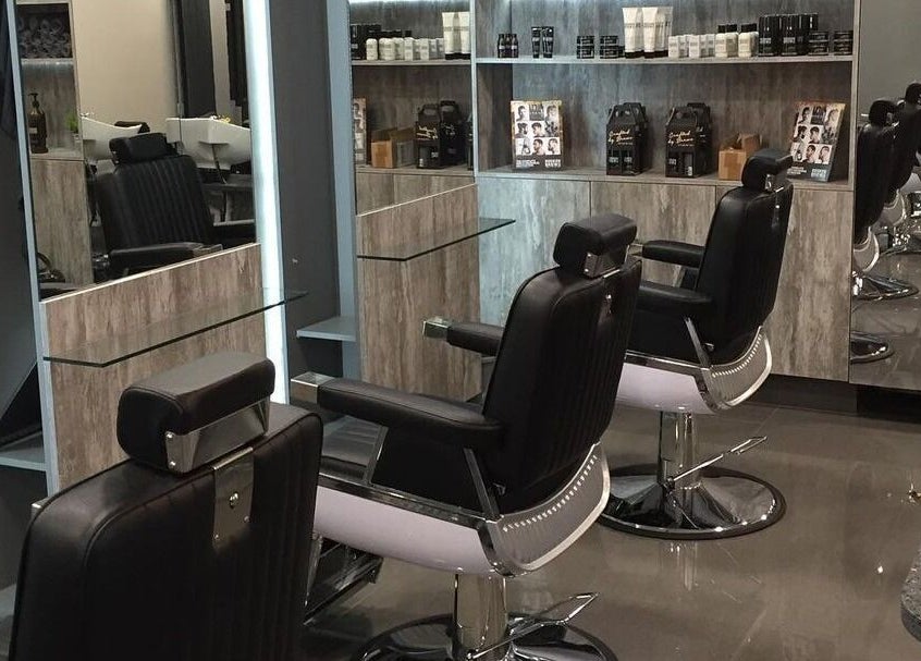 Chic interior of Chaps The Barbershop in Edinburgh, Scotland, GB, featuring sleek barber chairs and modern mirrors.