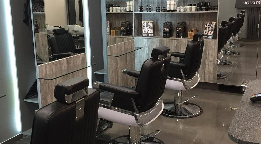 Chic interior of Chaps The Barbershop in Edinburgh, Scotland, GB, featuring sleek barber chairs and modern mirrors.