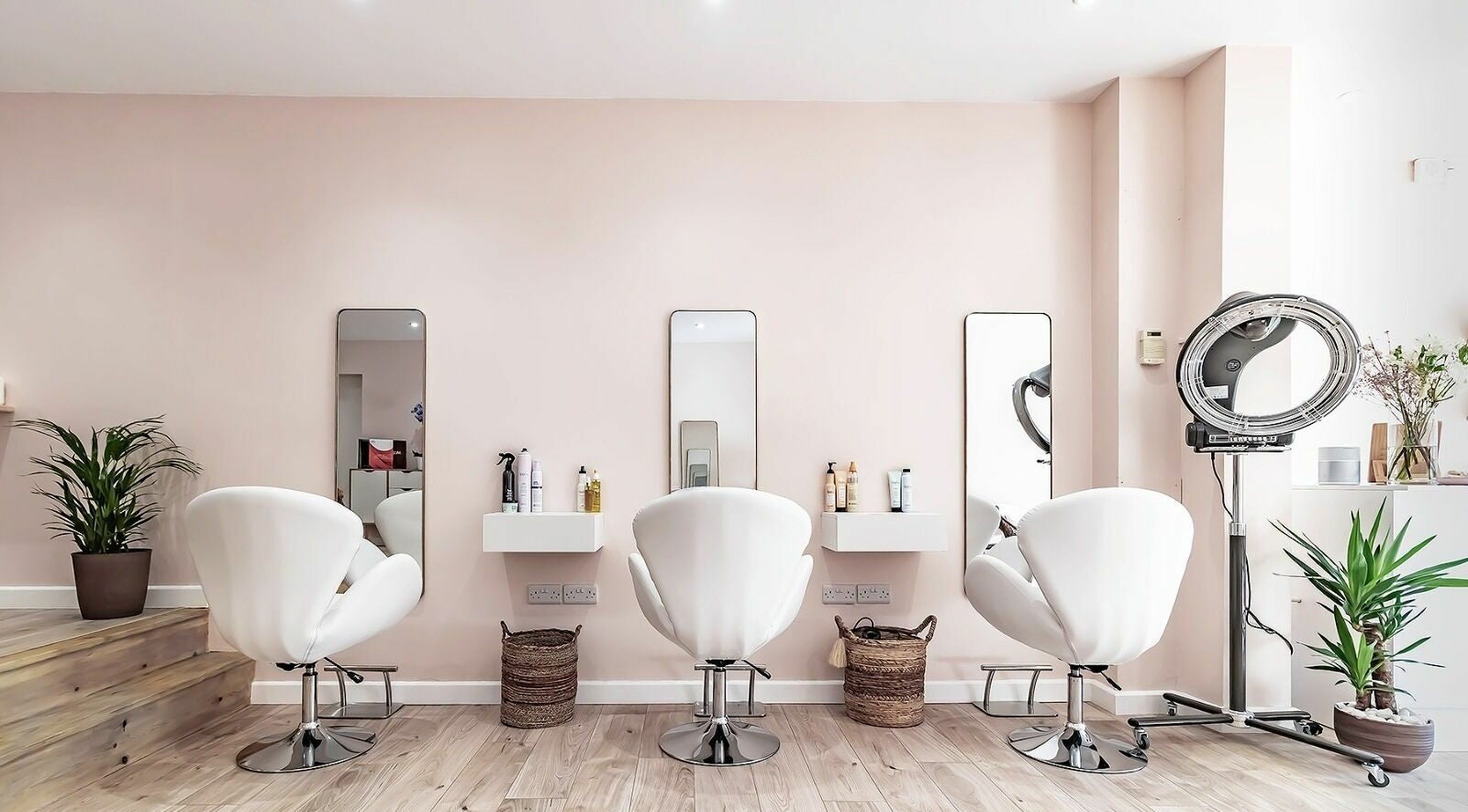 Modern salon interior at Luxe Hair Studio, Poole, England, GB with sleek chairs and mirrors.