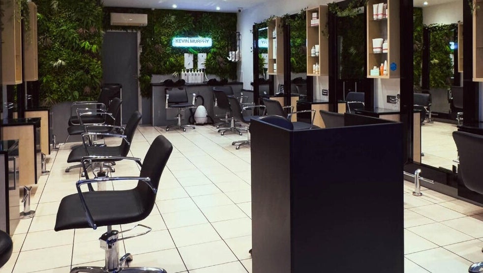 Chic interior of Cuts and Co, Armthorpe, England. Modern salon chairs and mirrors line the bright space.