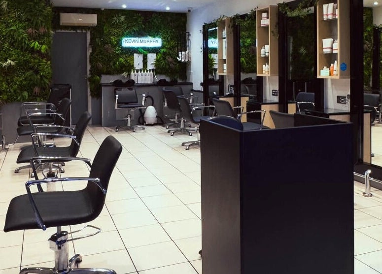 Chic interior of Cuts and Co, Armthorpe, England. Modern salon chairs and mirrors line the bright space.