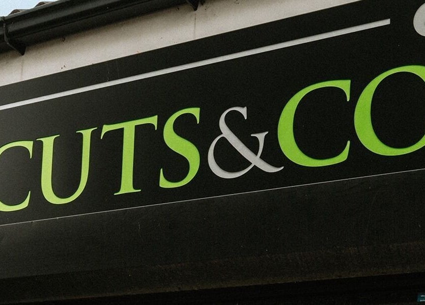 Cuts and Co storefront sign in Armthorpe, England, GB showcasing vibrant branding.