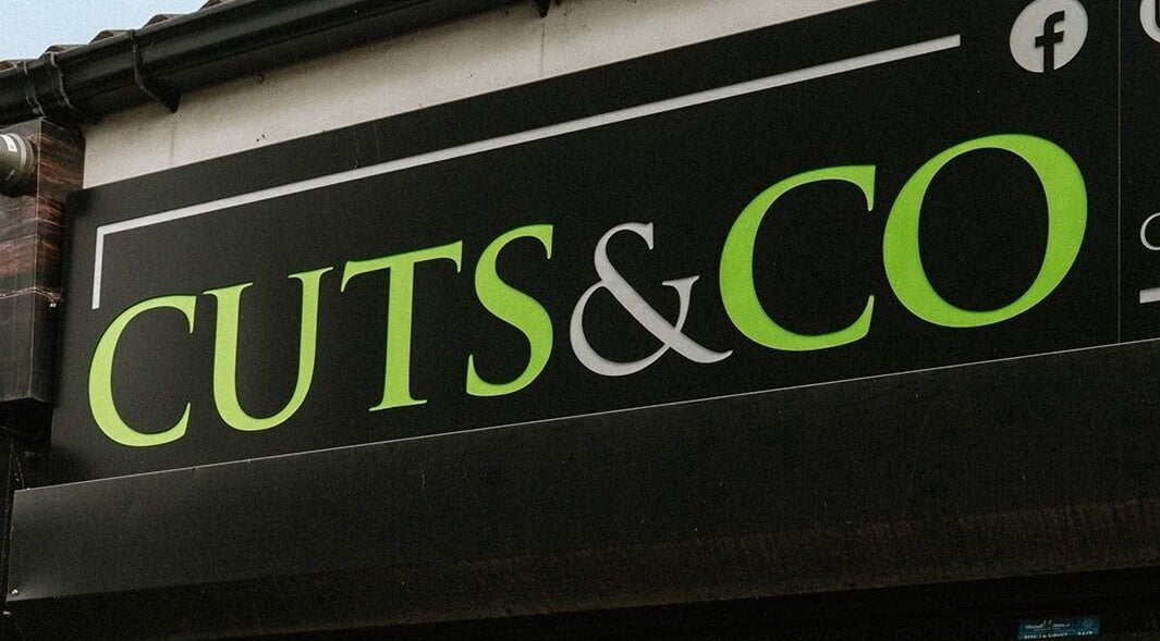 Cuts and Co storefront sign in Armthorpe, England, GB showcasing vibrant branding.