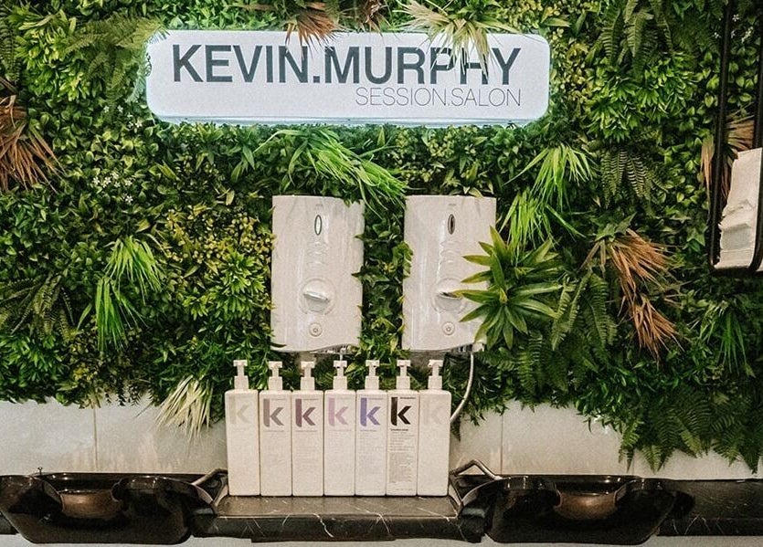 Stylish greenery wall with products at Cuts and Co, Armthorpe, England, GB.