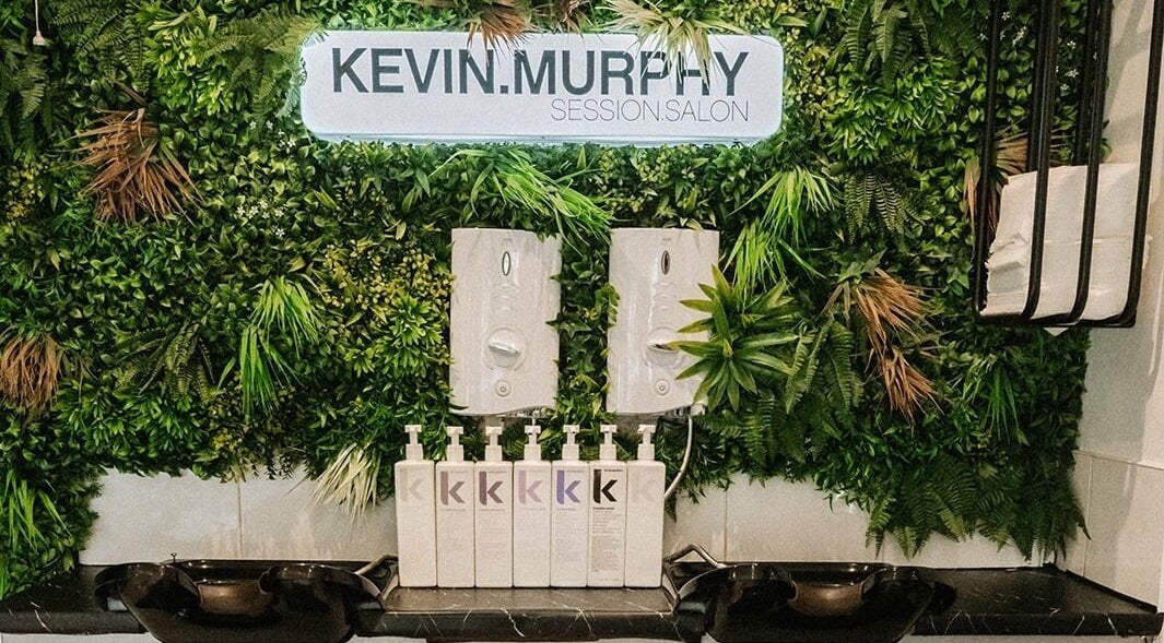 Stylish greenery wall with products at Cuts and Co, Armthorpe, England, GB.