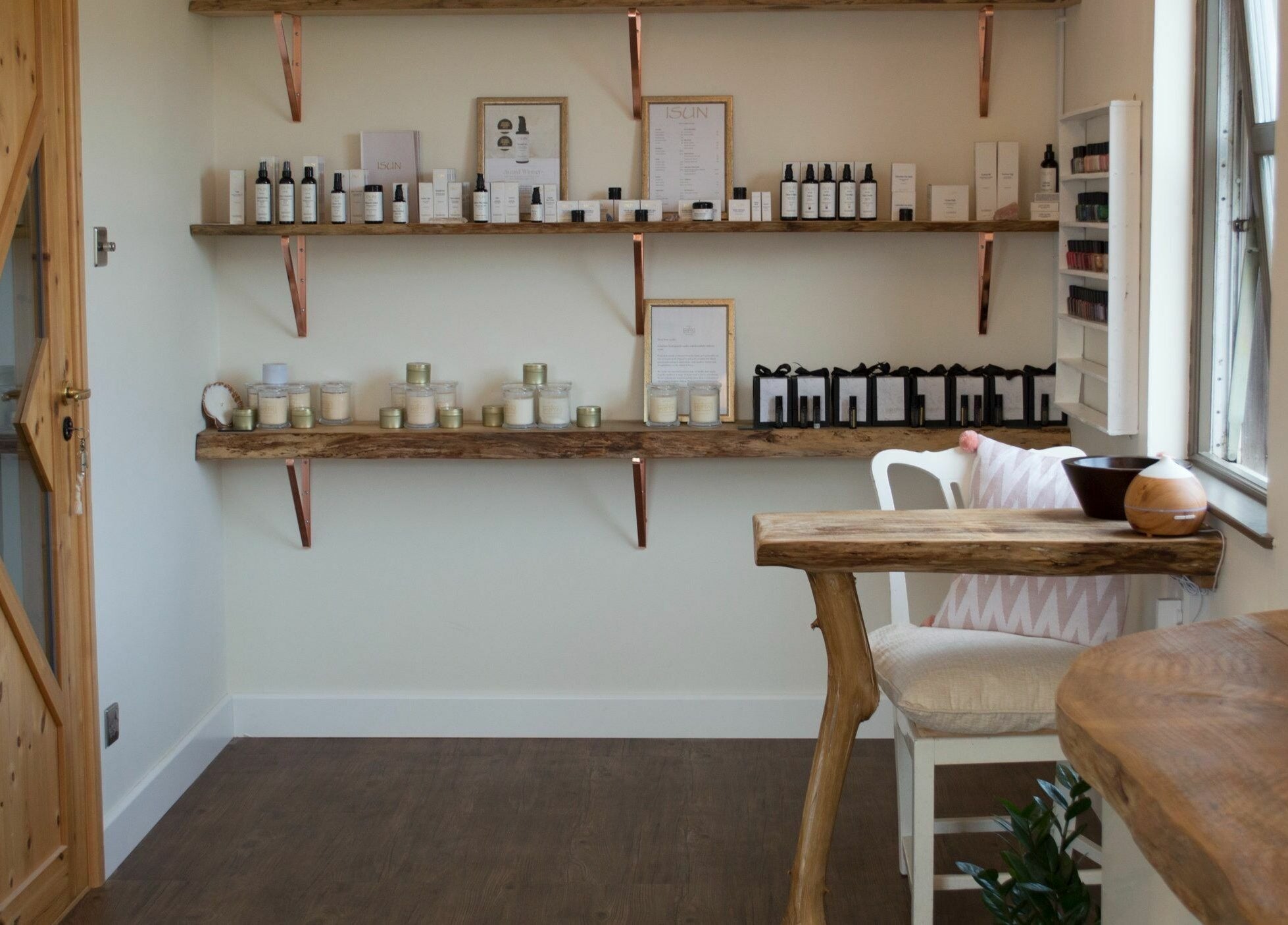 The Journey Studio at David Hick, Carrefour Selous, features a rustic wooden shelf with beauty products.