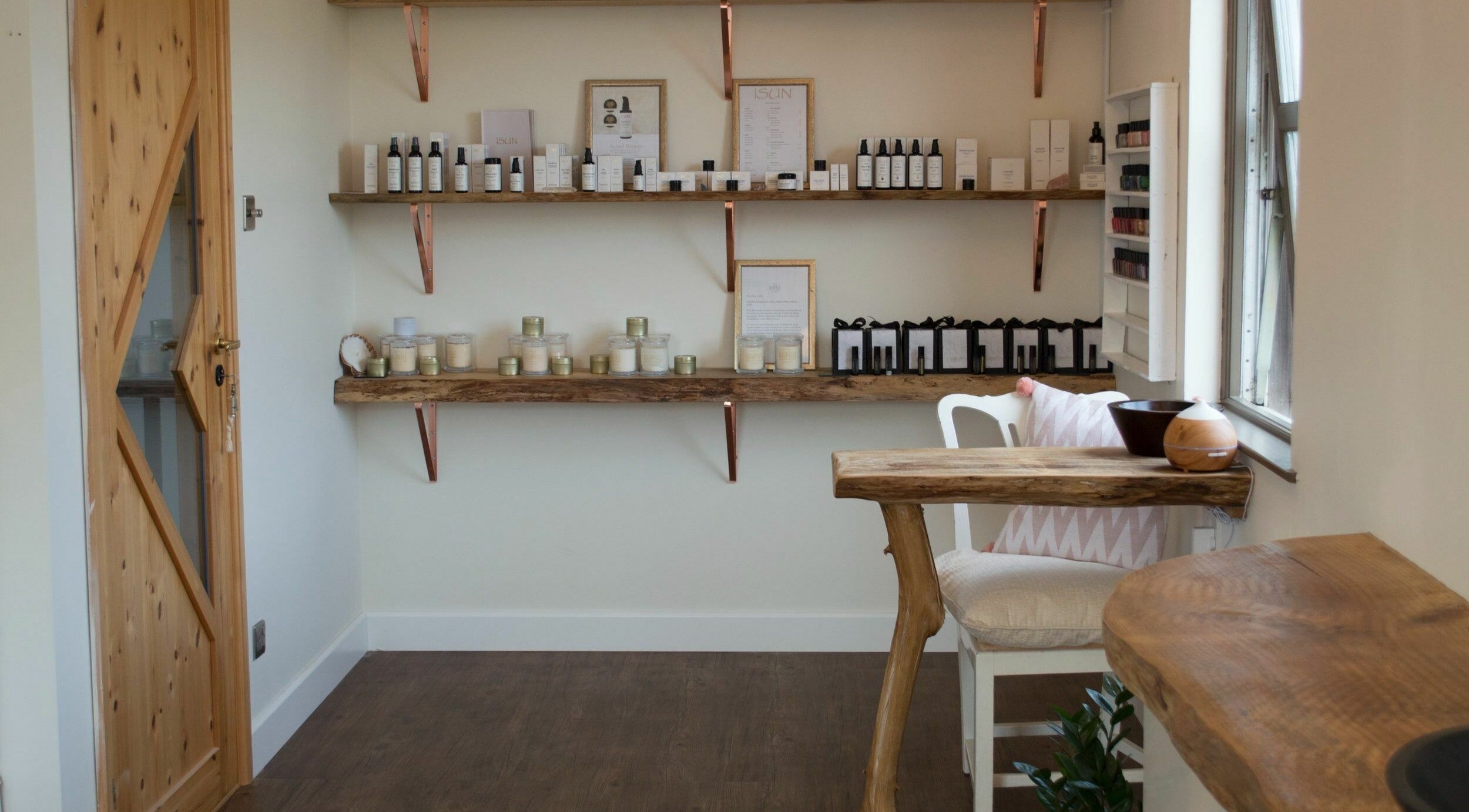 The Journey Studio at David Hick, Carrefour Selous, features a rustic wooden shelf with beauty products.