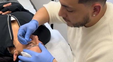 Expert applying precision eyebrow treatment at The Brow Lounge, El Paso, Texas, US.