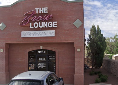 The Brow Lounge entrance in El Paso, Texas, US with red brick exterior and elegant signage.