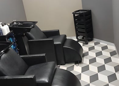 Modern salon chairs and washbasins at The Hair Movement, Durban, KwaZulu-Natal, ZA.