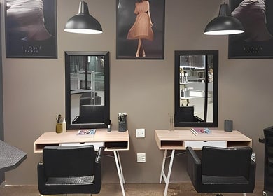 Modern salon stations at The Hair Movement in Durban, KwaZulu-Natal, ZA offering a chic styling experience.