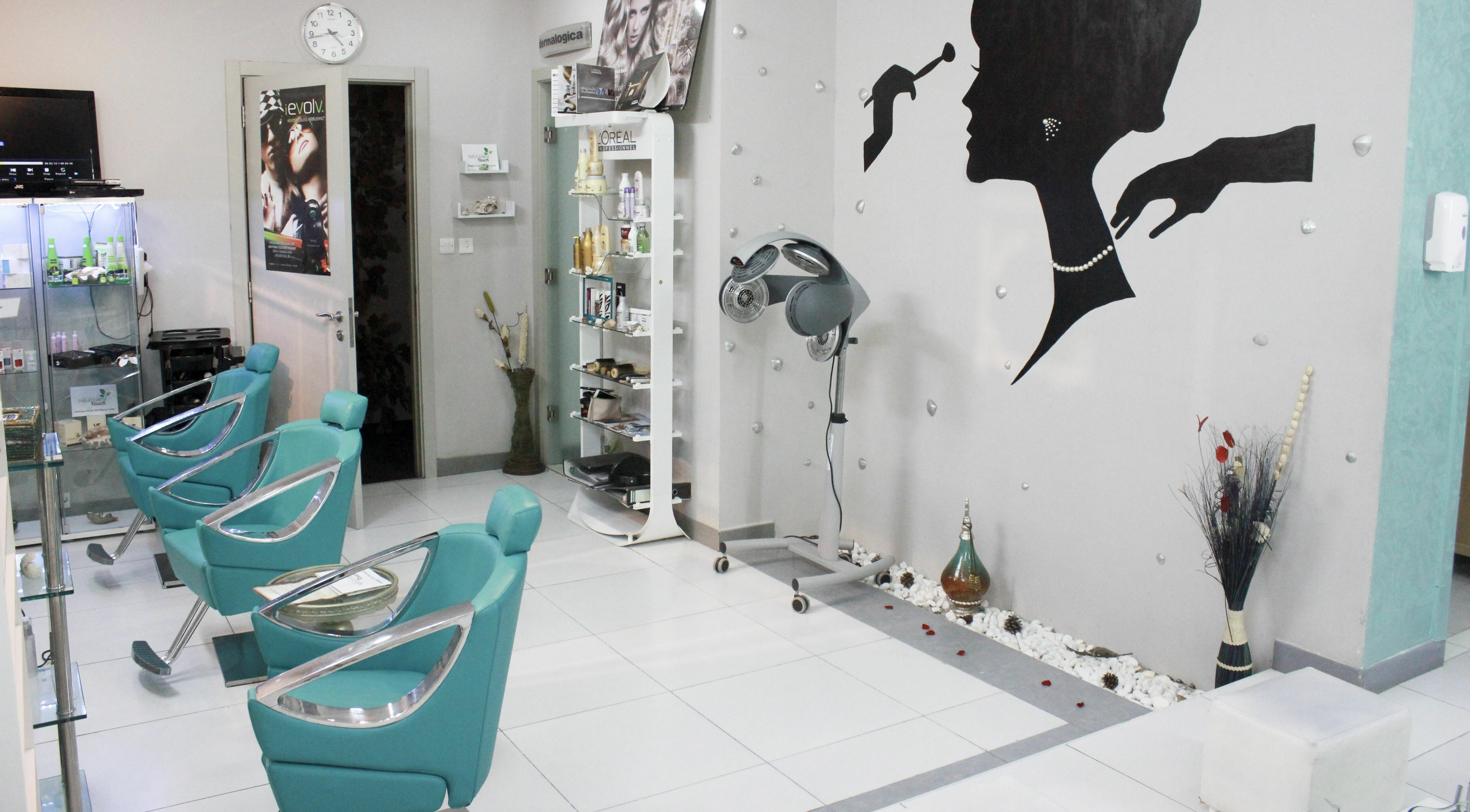 Interior of Naturopathy Touch Cluster D salon in Dubai, AE featuring modern styling chairs and decor.