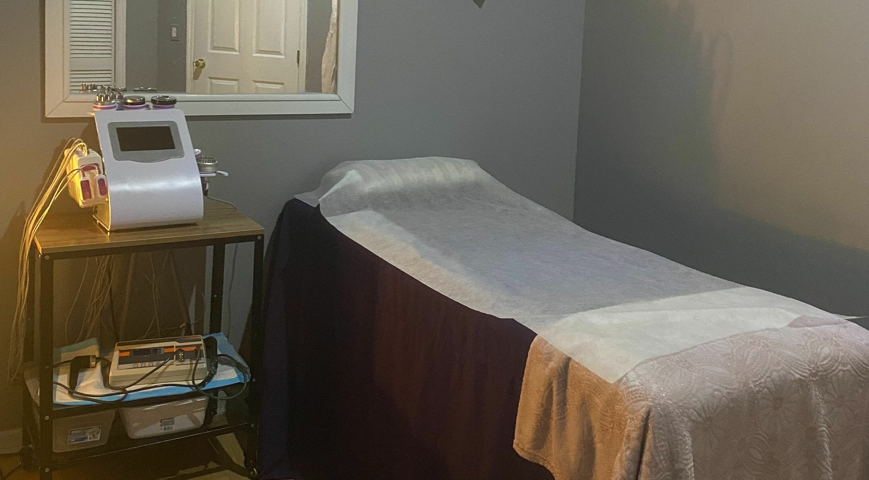 Peaceful massage room at Purple Rain Lymphatic Massage Spa, Tampa, Florida, US, with a cozy treatment bed.