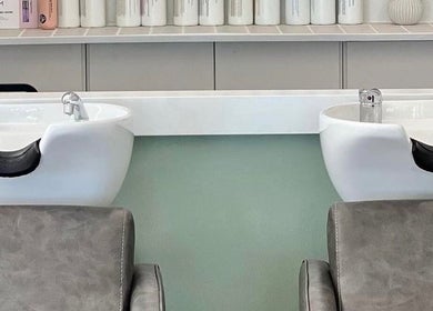 Modern hair washing stations at Katie Jones Hair, Windsor, Queensland, AU, showcasing elegant salon design.