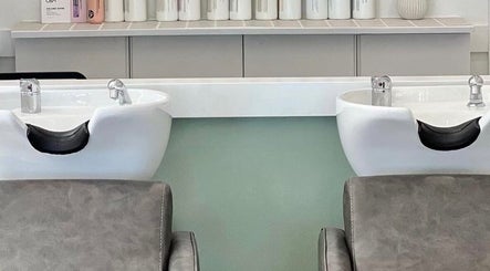 Modern hair washing stations at Katie Jones Hair, Windsor, Queensland, AU, showcasing elegant salon design.