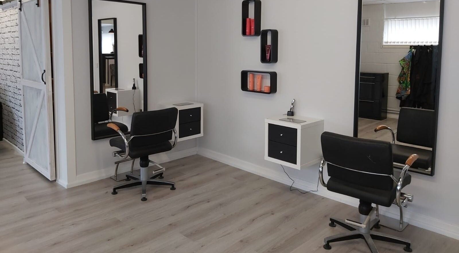 Modern salon styling chairs at Salon 10, Dalgety Bay, Scotland, GB, featuring elegant mirrors and decor.
