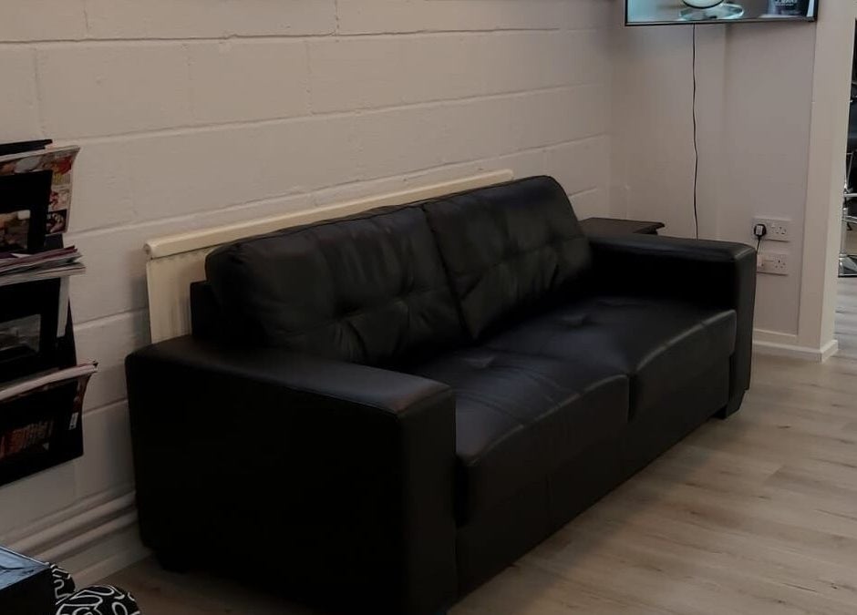 Comfortable black sofa in Salon 10's lobby, Dalgety Bay, Scotland, GB.