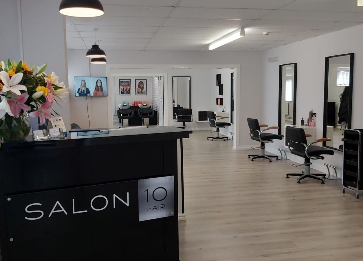 Modern interior of Salon 10 in Dalgety Bay, Scotland, GB, featuring sleek styling chairs and bright decor.