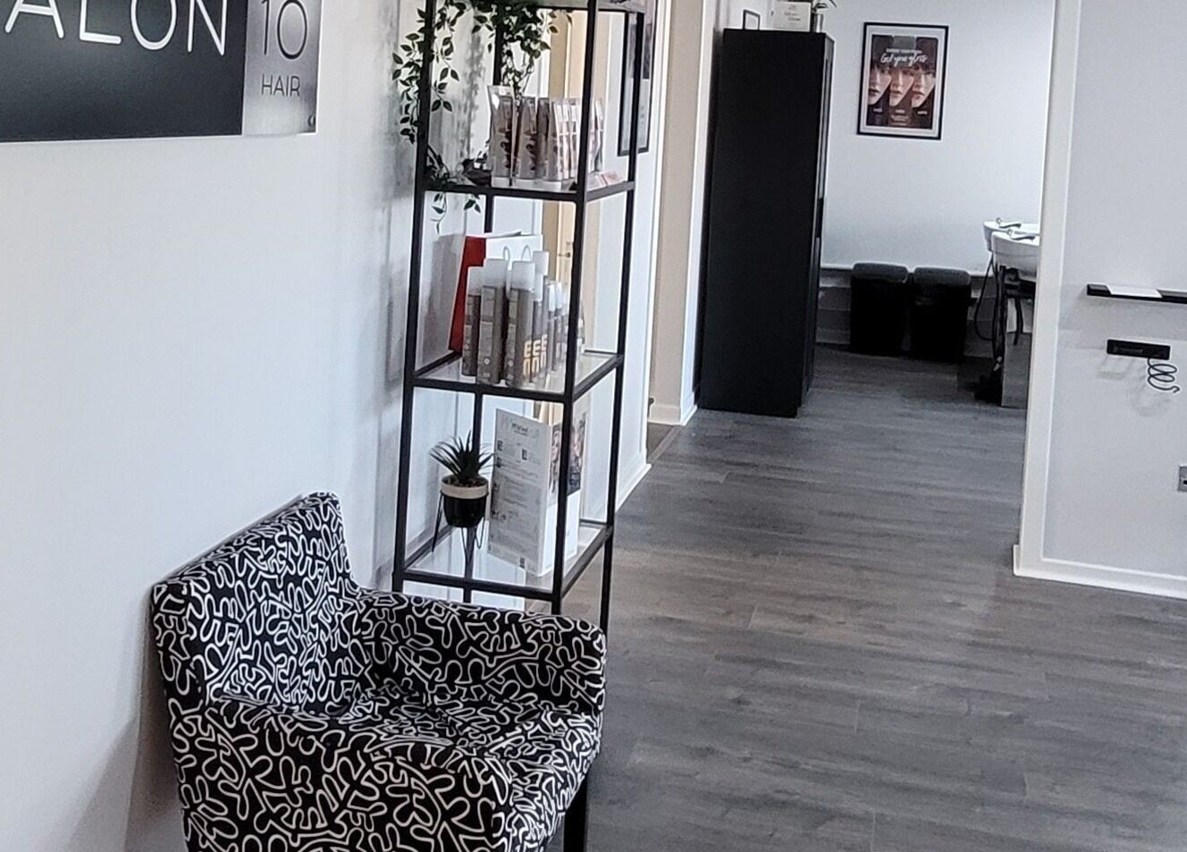 Elegant Salon 10 interior with modern decor in Dalgety Bay, Scotland, GB, featuring stylish seating and shelving.