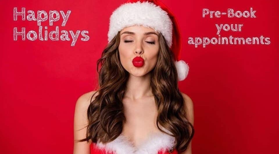 Festive woman with Santa hat at Balayage Hair Salon in El Paso, Texas, US. Pre-book your holiday appointments.