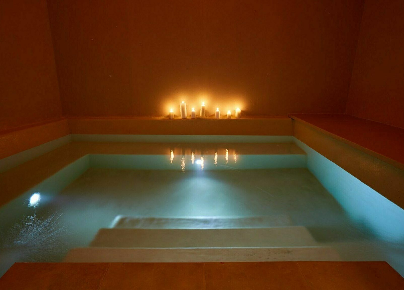 Tranquil candlelit pool at Eressian Hammam and Spa, Ερεσός, GR, offering a serene wellness experience.
