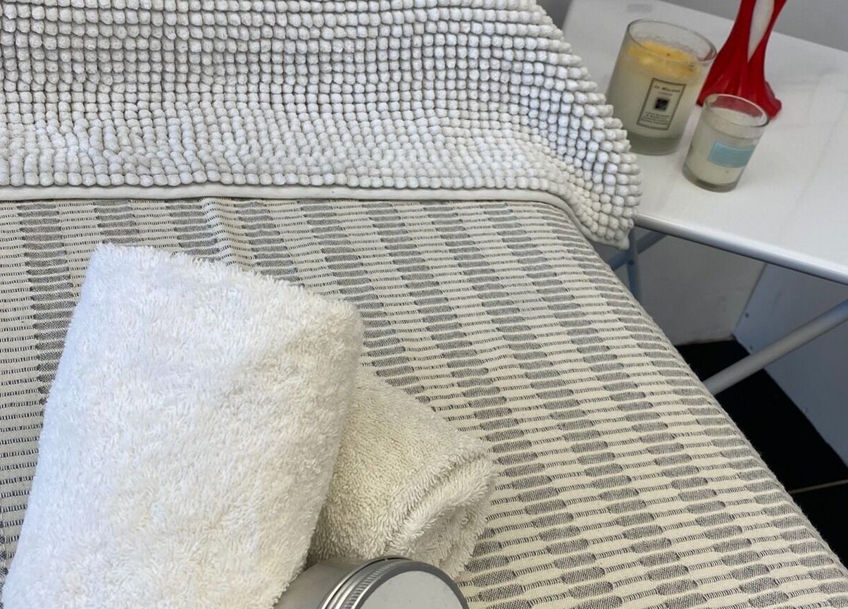 Relaxing spa setup with towels and candles at GlamLift, Edinburgh, Scotland, GB.