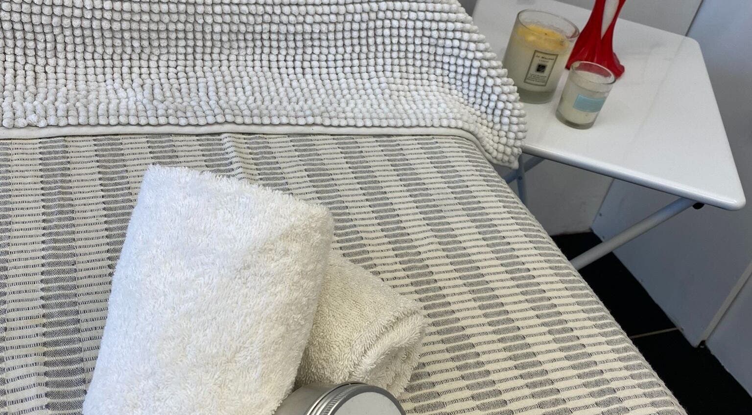 Relaxing spa setup with towels and candles at GlamLift, Edinburgh, Scotland, GB.