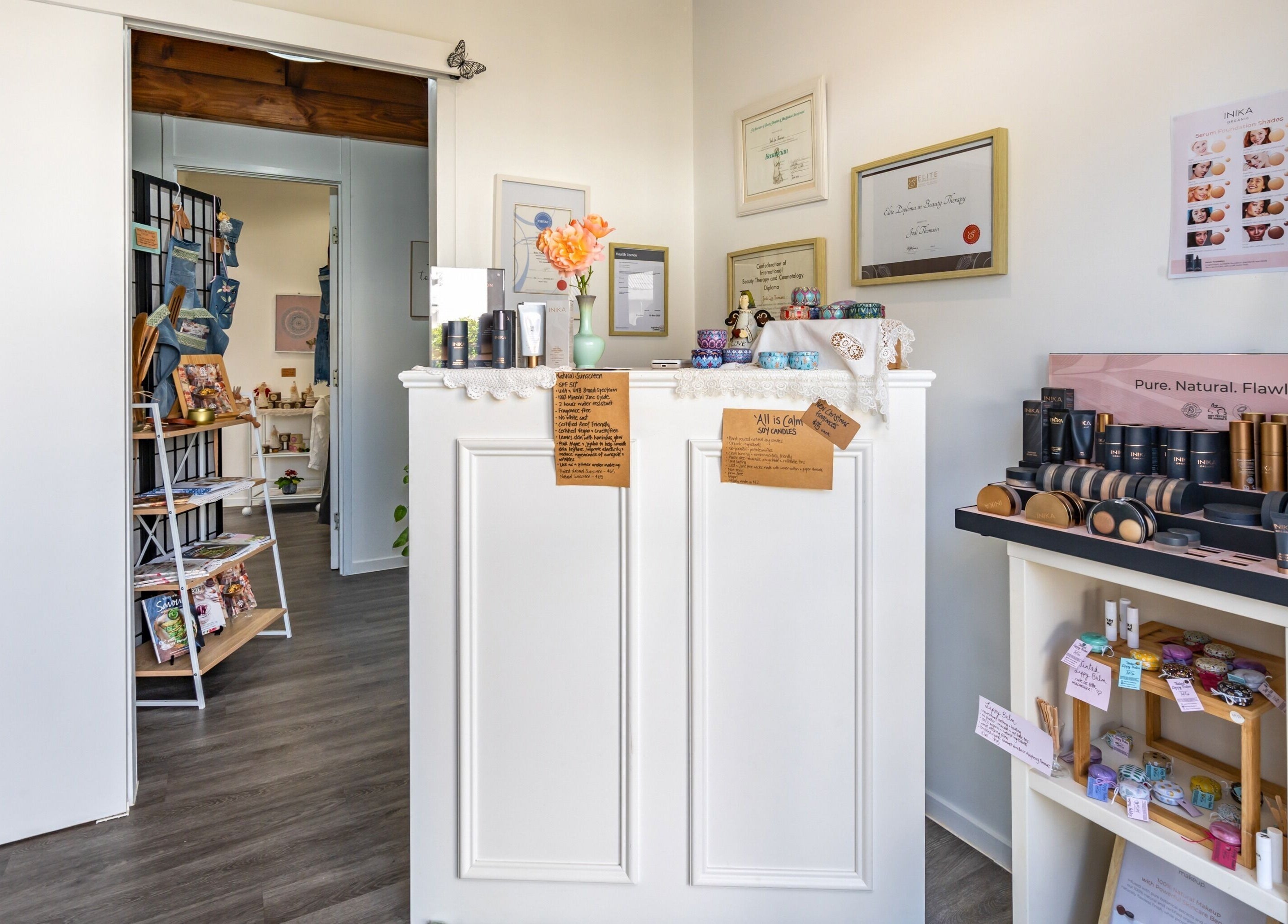 Reception area of Jodi Lea Natural Beauty, Auckland, NZ, featuring cosmetics and elegant decor.