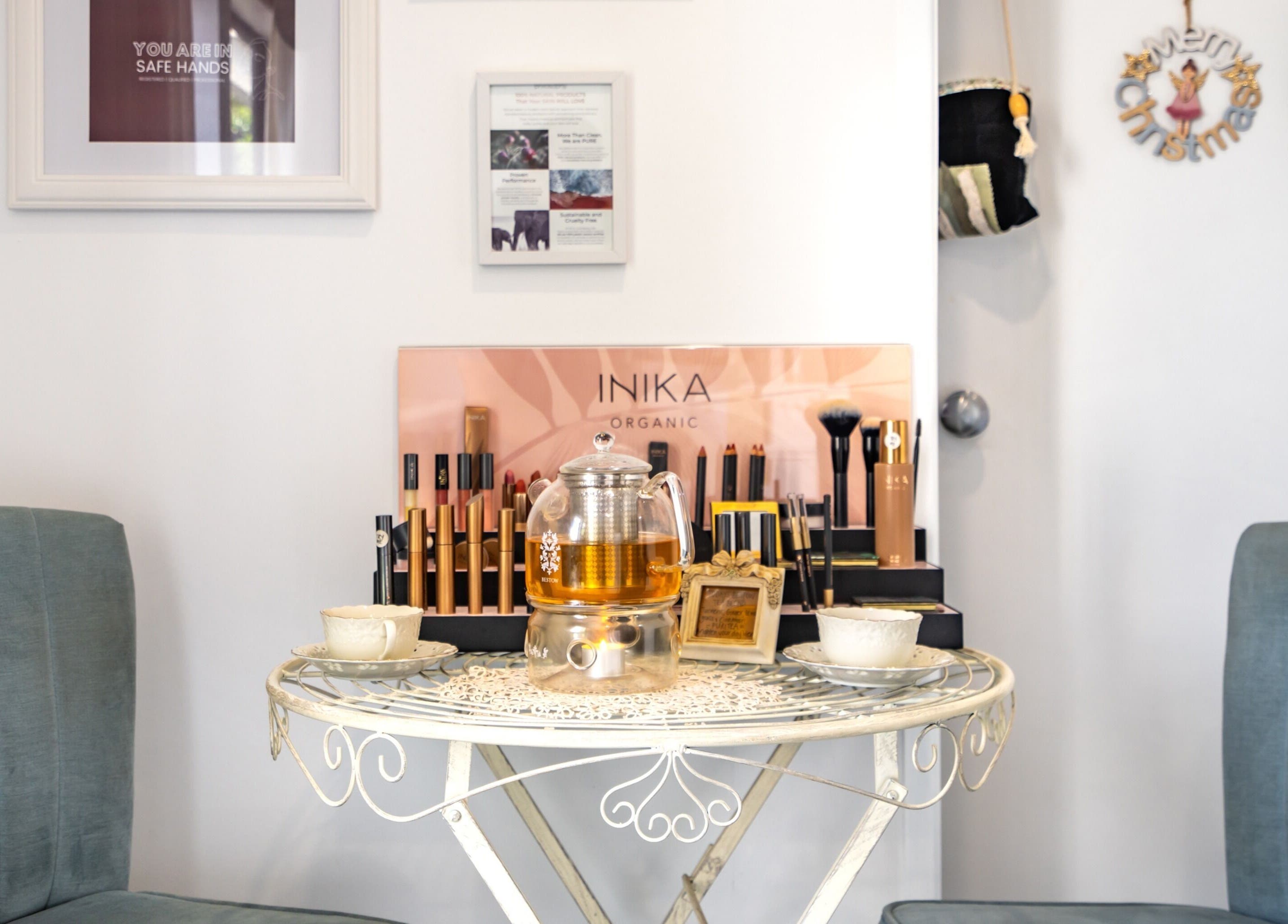 Inviting tea setup at Jodi Lea Natural Beauty, Auckland, NZ, with cozy seating by organic cosmetics display.