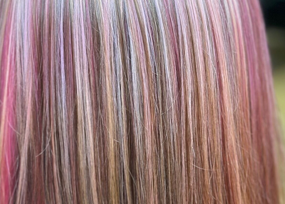 Sally Hoo salon in Hagerstown, Maryland, US showcases vibrant, multi-colored hair highlights.