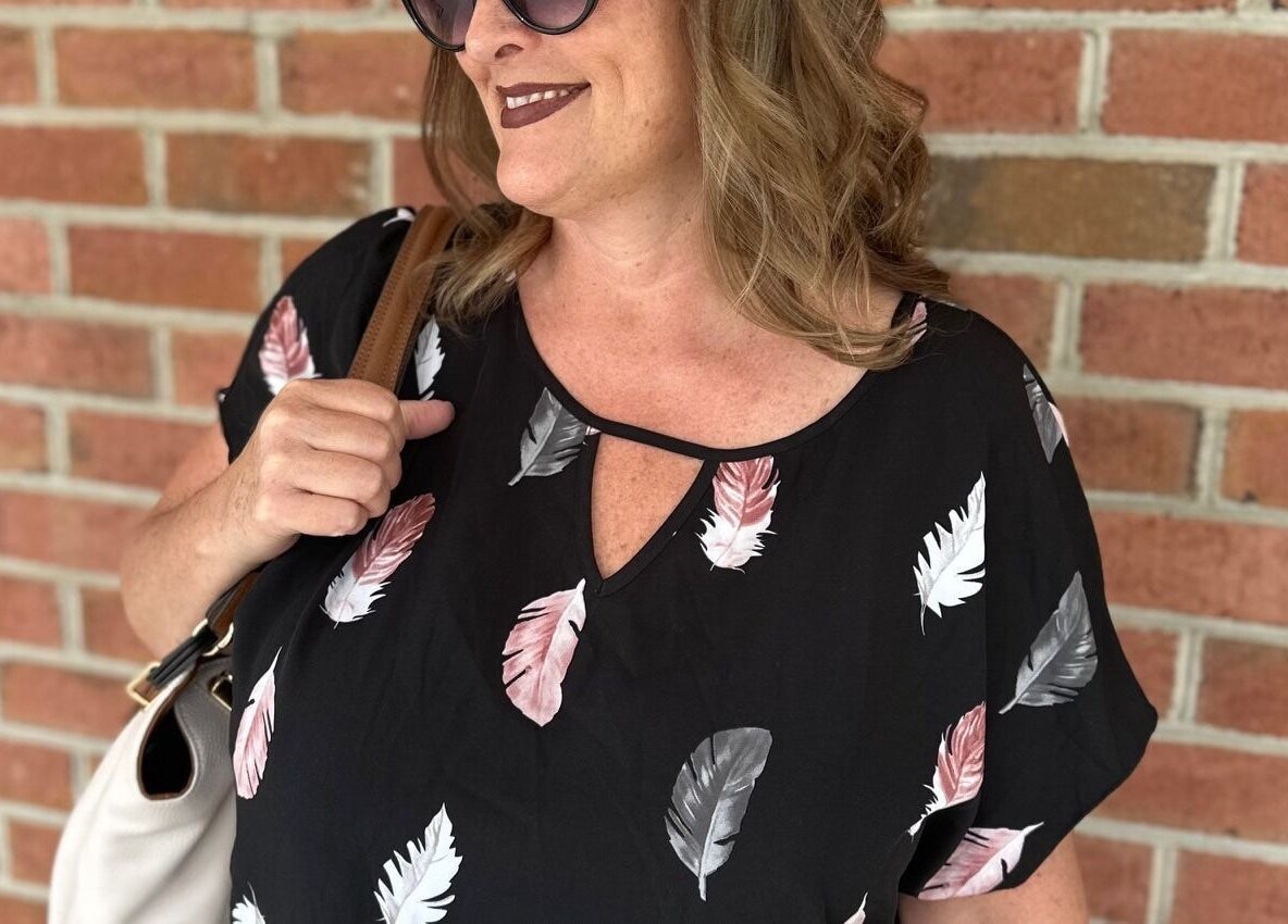 Visitor at Sally Hoo in Hagerstown, Maryland, US, poses stylishly against a brick wall.
