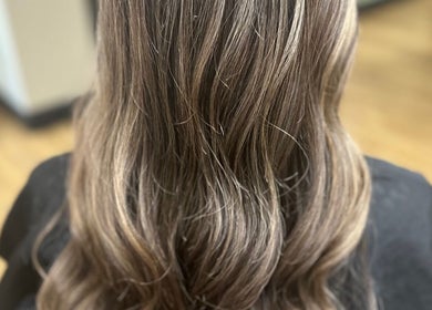 Long, wavy hair styled at Sally Hoo salon in Hagerstown, Maryland, US with soft highlights.
