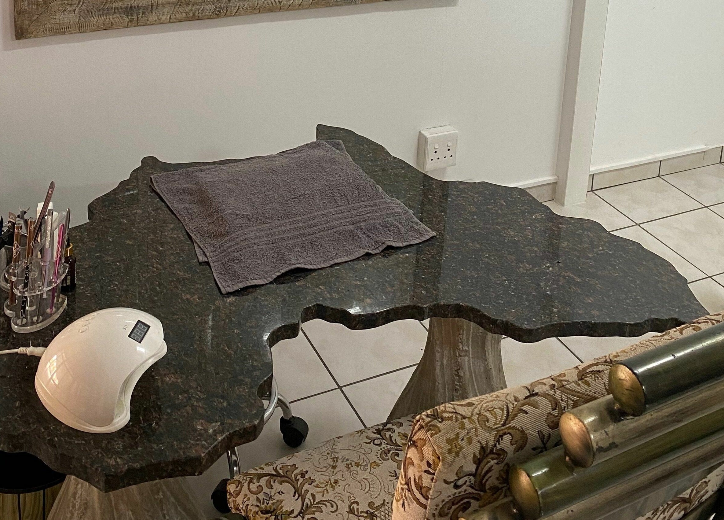 Sublimity nail station in Modimolle, Limpopo, ZA with ornate chair and sleek manicure tools.