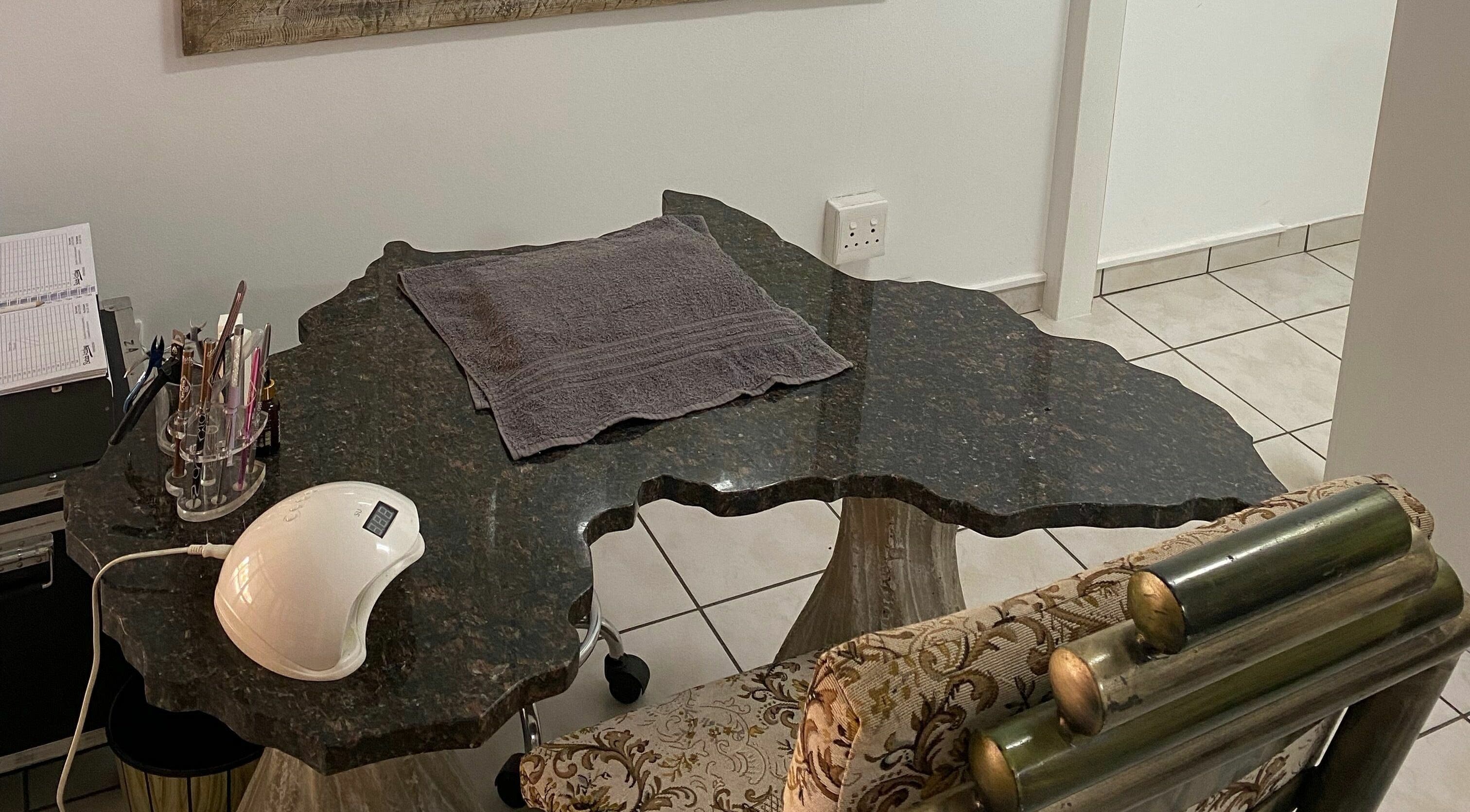 Sublimity nail station in Modimolle, Limpopo, ZA with ornate chair and sleek manicure tools.