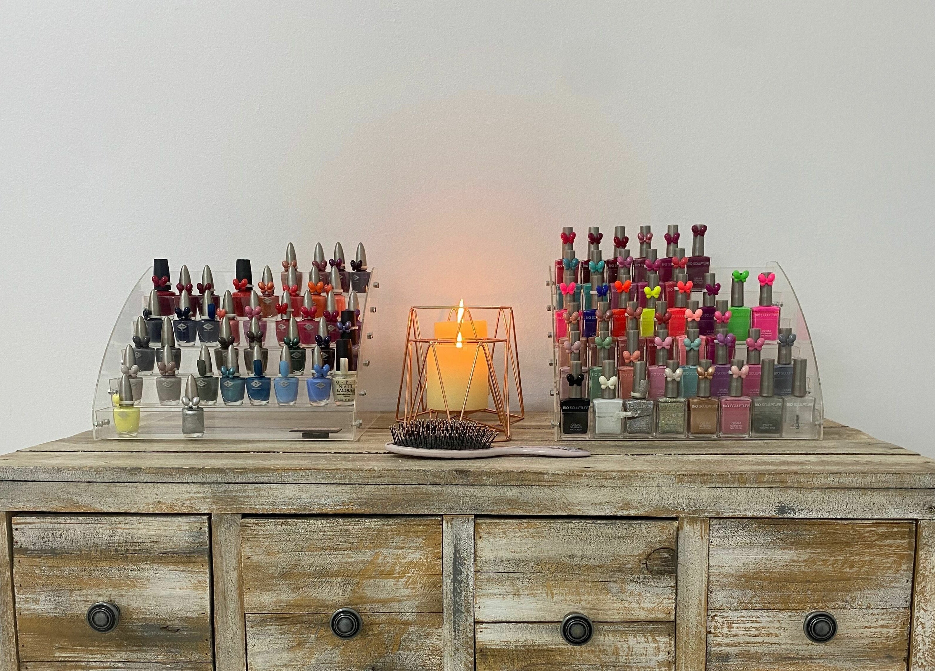 Nail polish collection at Sublimity, Modimolle, Limpopo, ZA with a glowing candle centerpiece.
