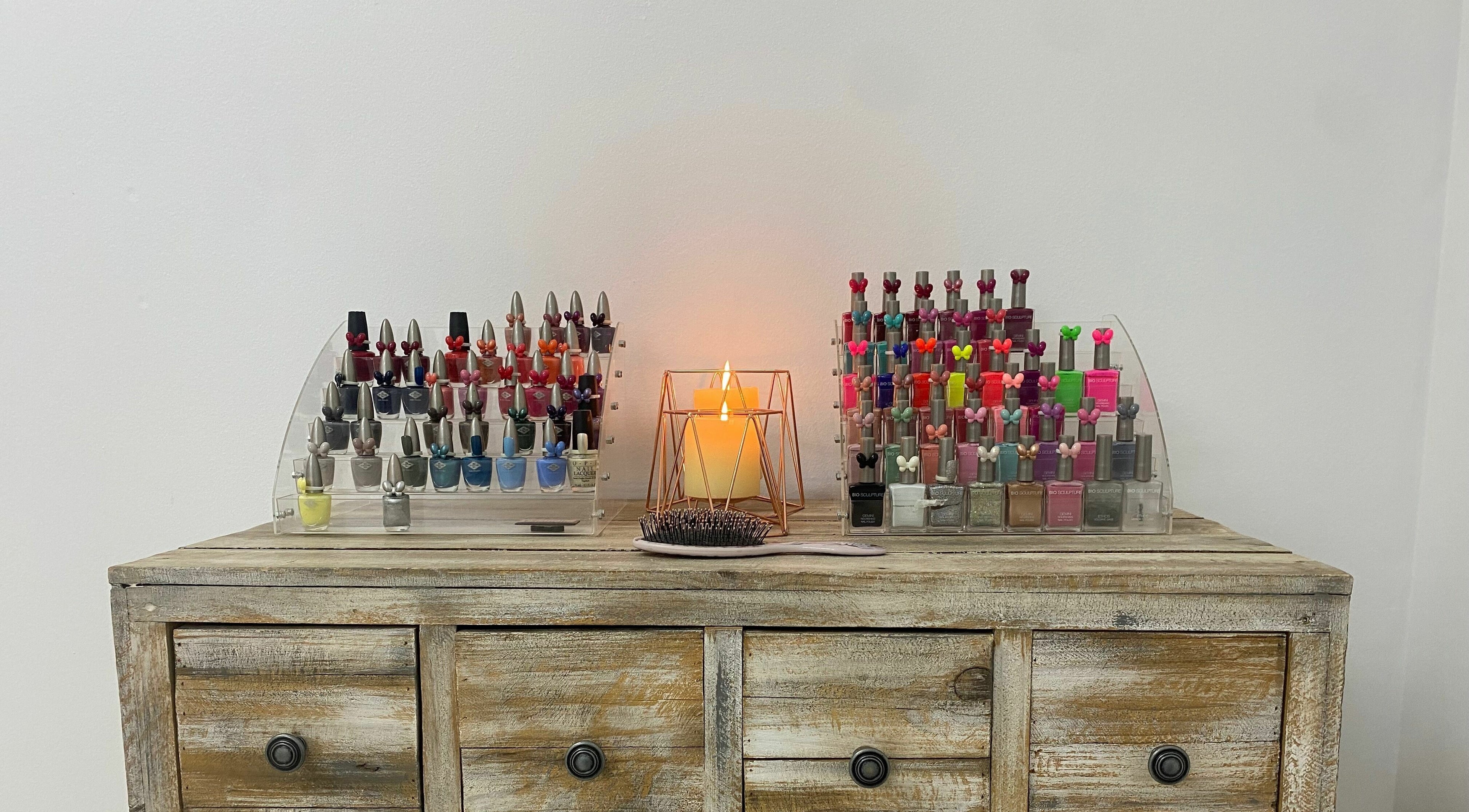 Nail polish collection at Sublimity, Modimolle, Limpopo, ZA with a glowing candle centerpiece.