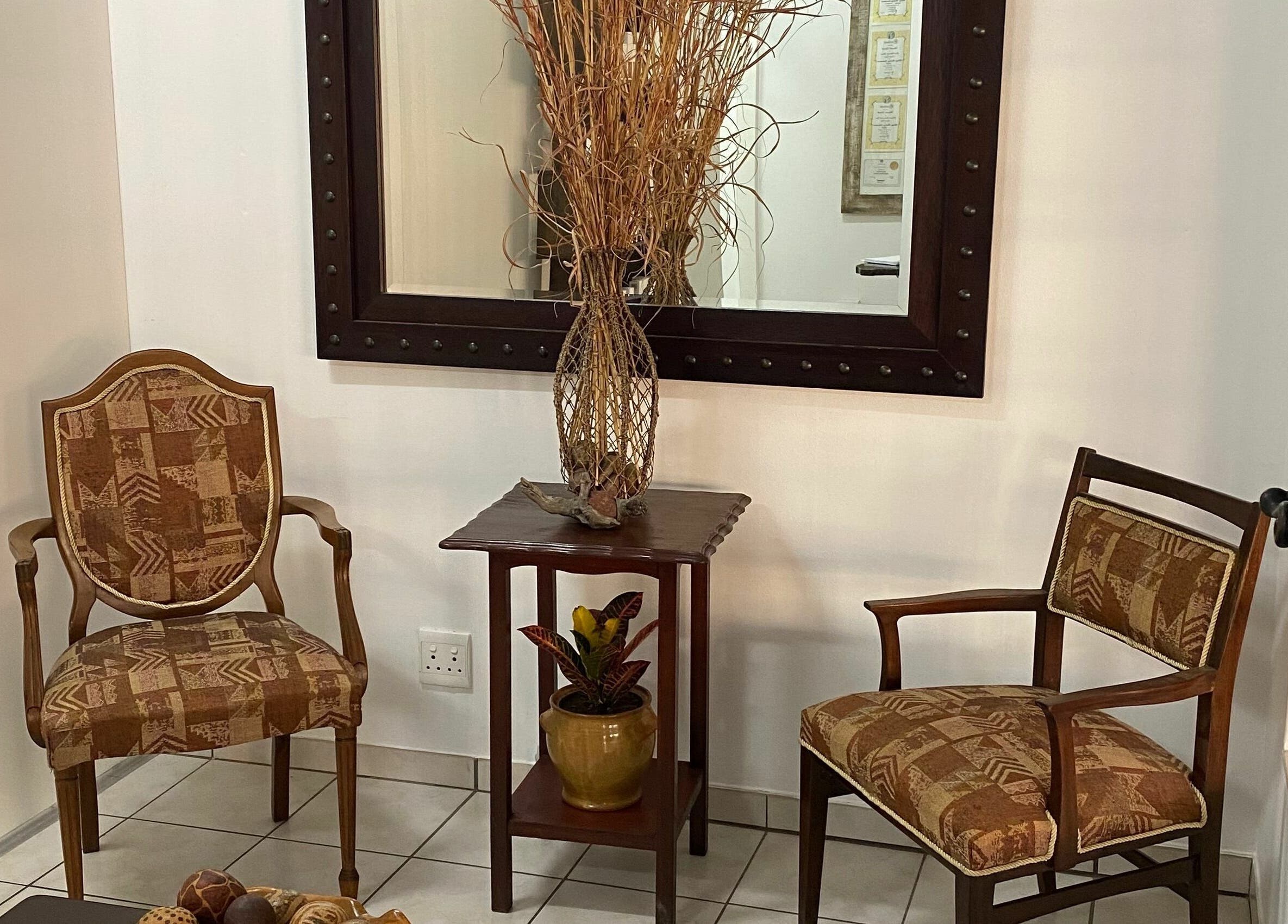 Charming lobby seating with wooden chairs and decor at Sublimity, Modimolle, Limpopo, ZA.