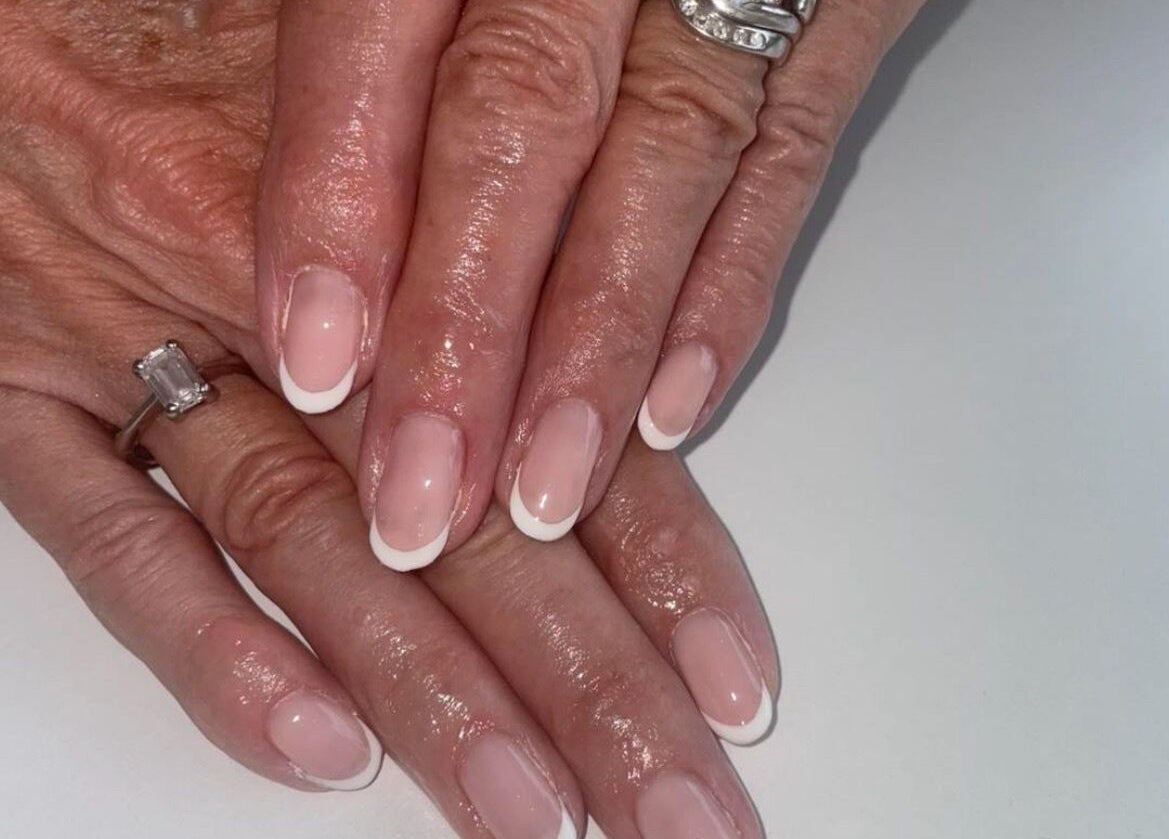 Elegant French manicure at BARE in Port Glasgow, Scotland, GB, showcasing refined nail art design.