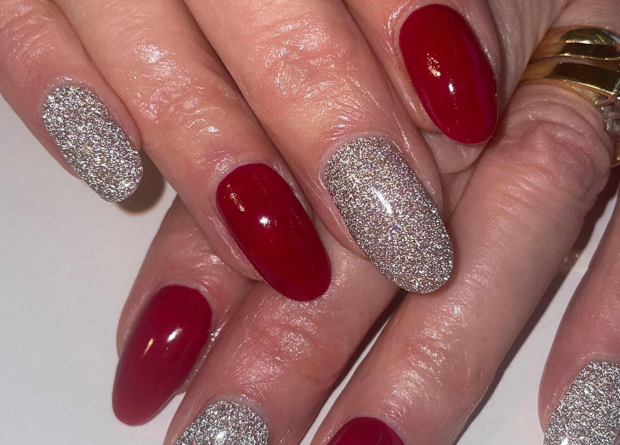 Stylish red and glitter nail art at BARE in Port Glasgow, Scotland, GB. Chic and trendy manicure design.
