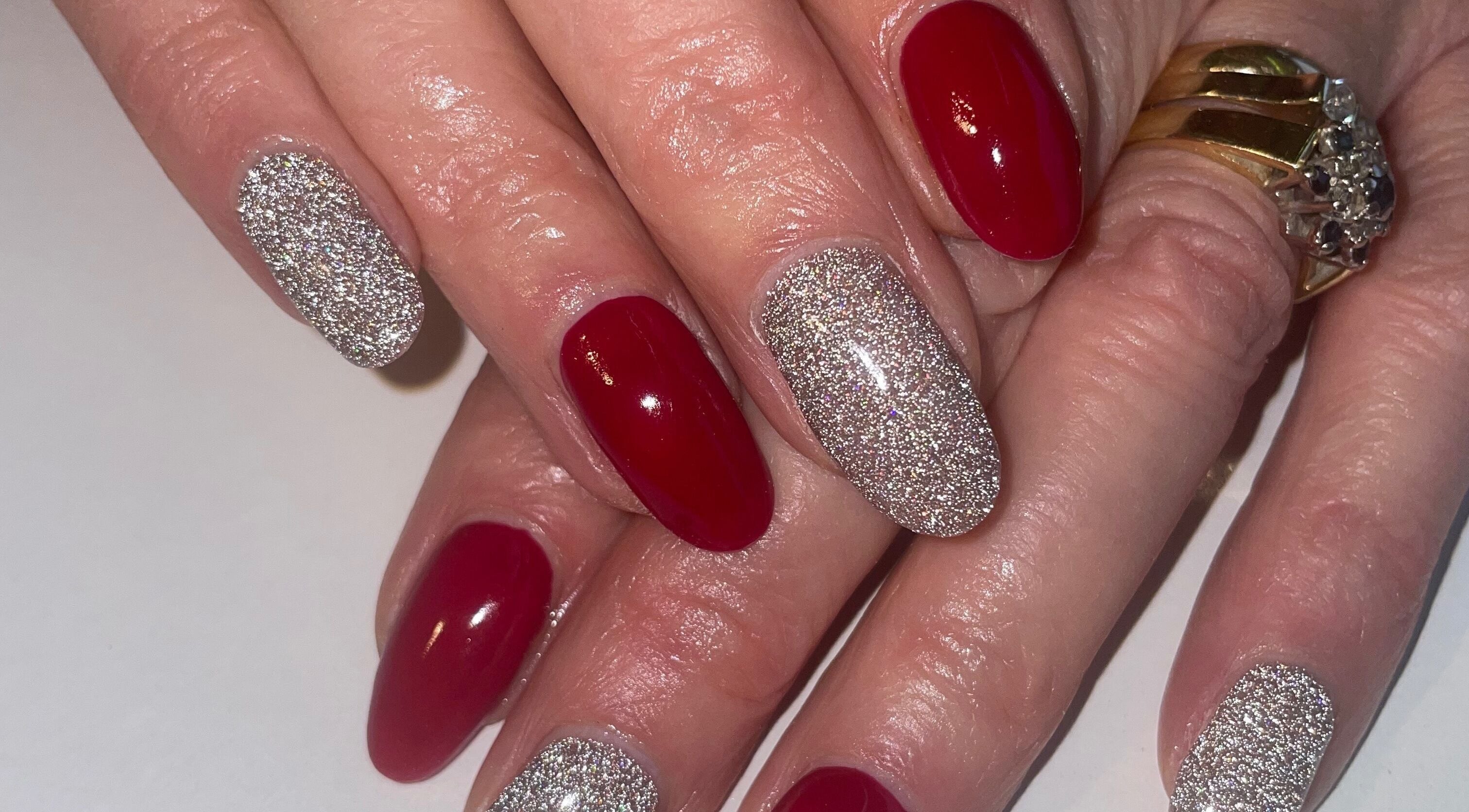Stylish red and glitter nail art at BARE in Port Glasgow, Scotland, GB. Chic and trendy manicure design.