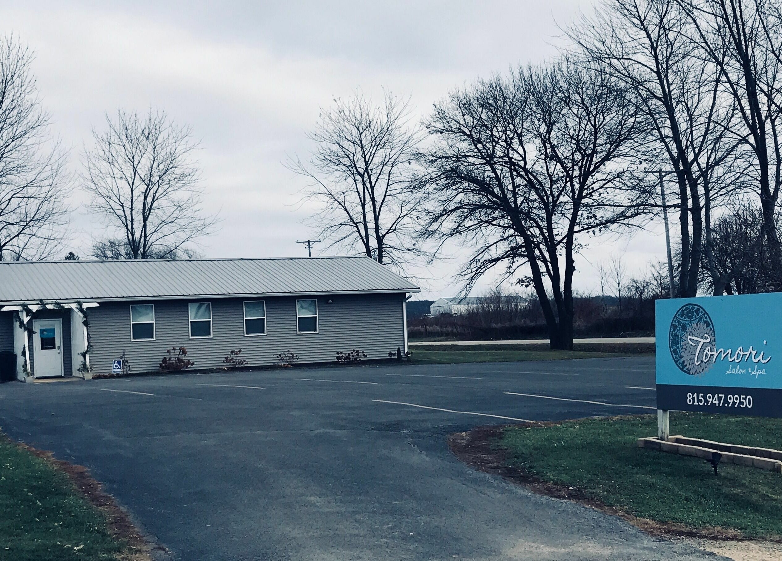 Country Roots entrance in Stockton, Illinois, showcasing a serene, rustic setting with ample parking.