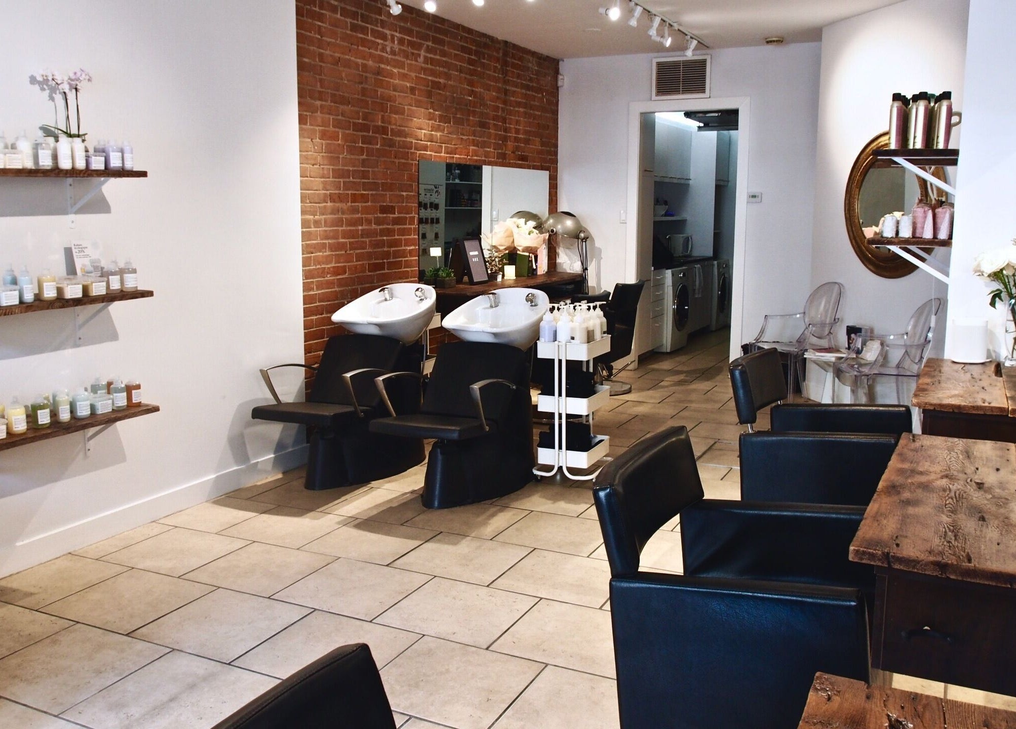 Elegant salon setup at Maison L.A.B, Montréal, Québec, CA with styling chairs and product shelves.