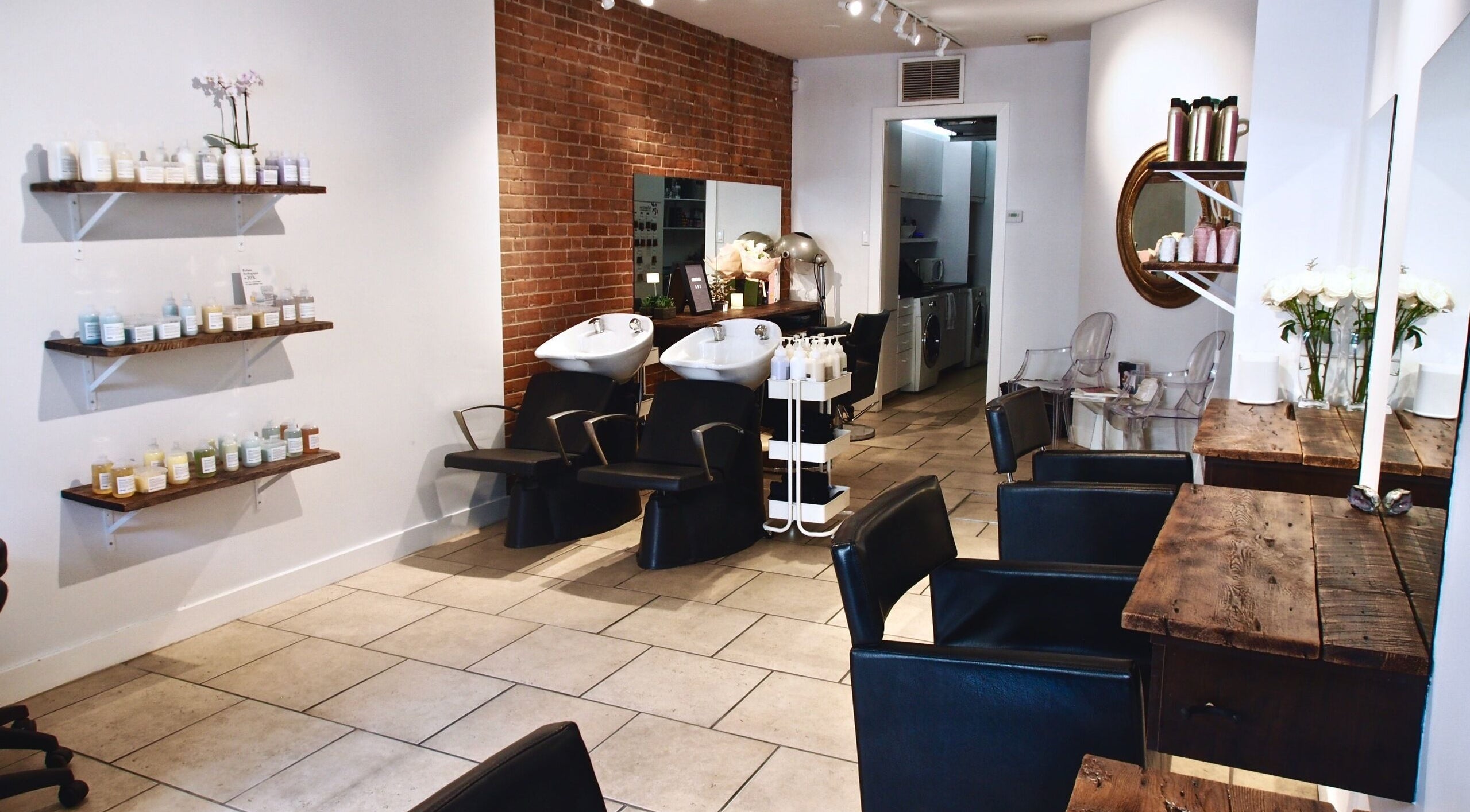 Elegant salon setup at Maison L.A.B, Montréal, Québec, CA with styling chairs and product shelves.