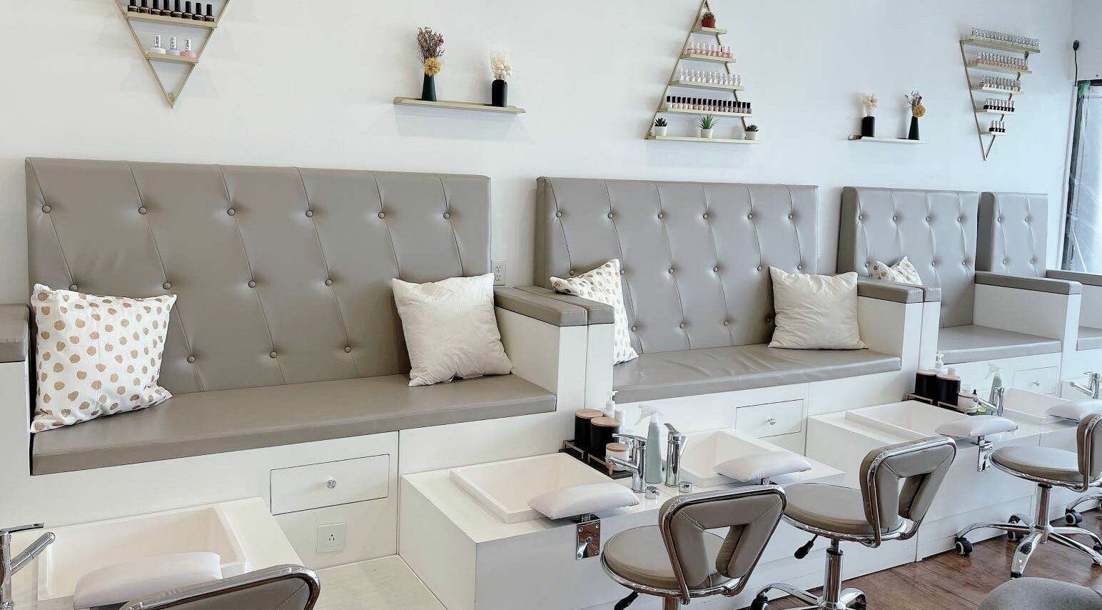 Modern pedicure stations at Kuo Qi Nails, Toronto, Ontario, CA with elegant seating and decor.