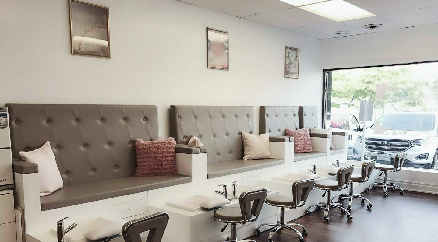 Elegant nail salon seating at Kuo Qi Nails, Toronto, Ontario, CA, featuring plush chairs and modern decor.