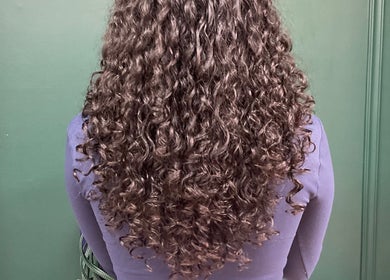 Back view of voluminous curly hair at DeityMANE Salon space, London, England, GB.